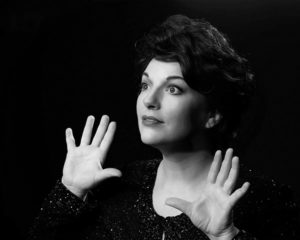 Katy Gentry, singer, posing under stagelights.